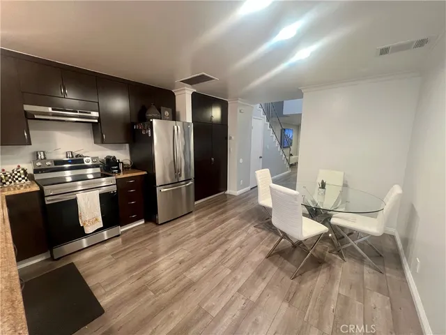 a kitchen with a sink appliances and cabinets