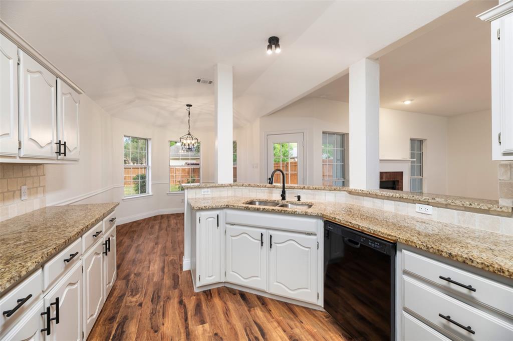 215 Barbara Way Red Oak, TX 75154 - Photo 12 of 36 Open kitchen with everyday convenience — generous cabinet storage and granite counters create an efficient layout for cooking, serving, and casual gathering.