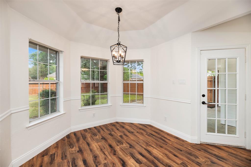215 Barbara Way Red Oak, TX 75154 - Photo 14 of 36 Light-filled dining area offers flexible use, with windows, exterior access, and space that could work for dining, plants, or a small sitting area.