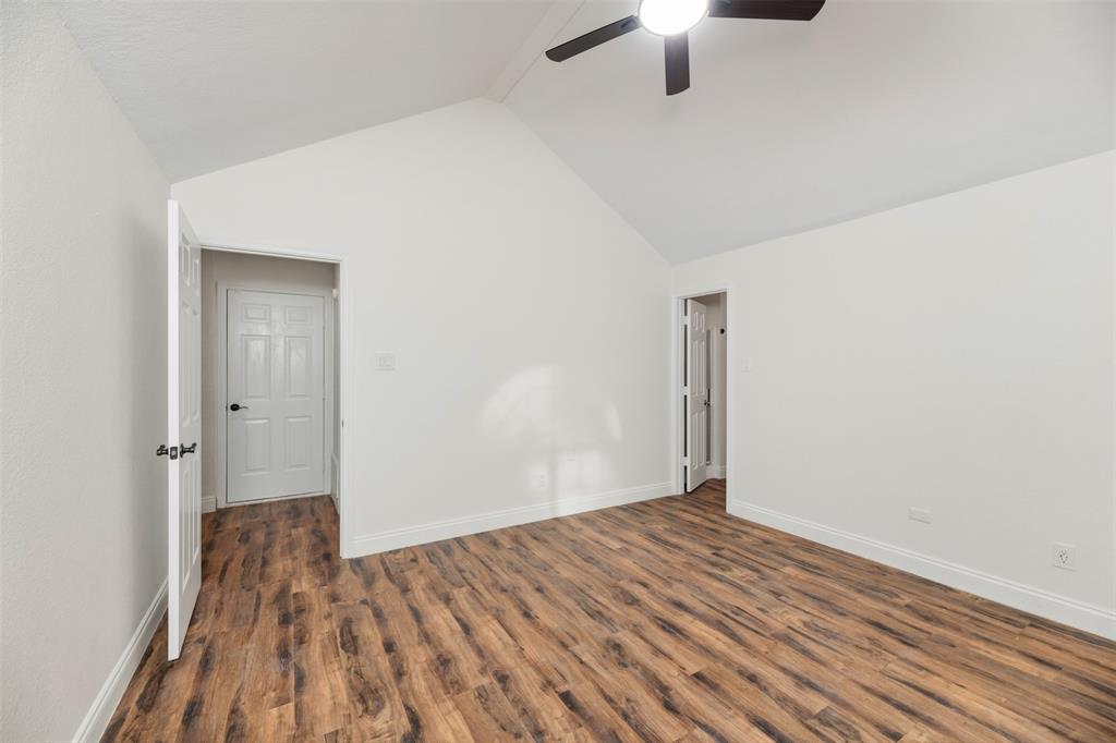 215 Barbara Way Red Oak, TX 75154 - Photo 16 of 36 Comfortable primary bedroom with neutral walls and updated flooring, ready for a buyer to make it their own without sacrificing affordability.