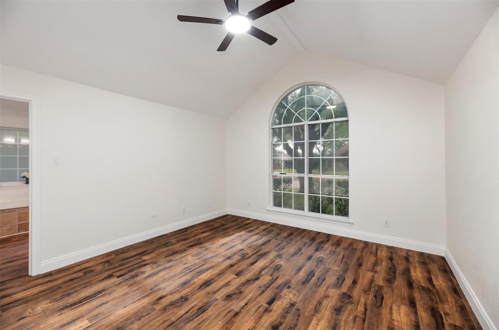 215 Barbara Way Red Oak, TX 75154 - Photo 17 of 36 Primary bedroom with arched window detail, bringing in natural light with vaulted ceiling and a new ceiling fan.