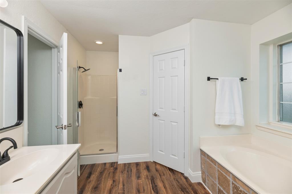 215 Barbara Way Red Oak, TX 75154 - Photo 20 of 36 Spacious primary bath with double vanity — designed for easy routines with two sinks, a separate soaking tub, walk-in shower, and a bright neutral finish.