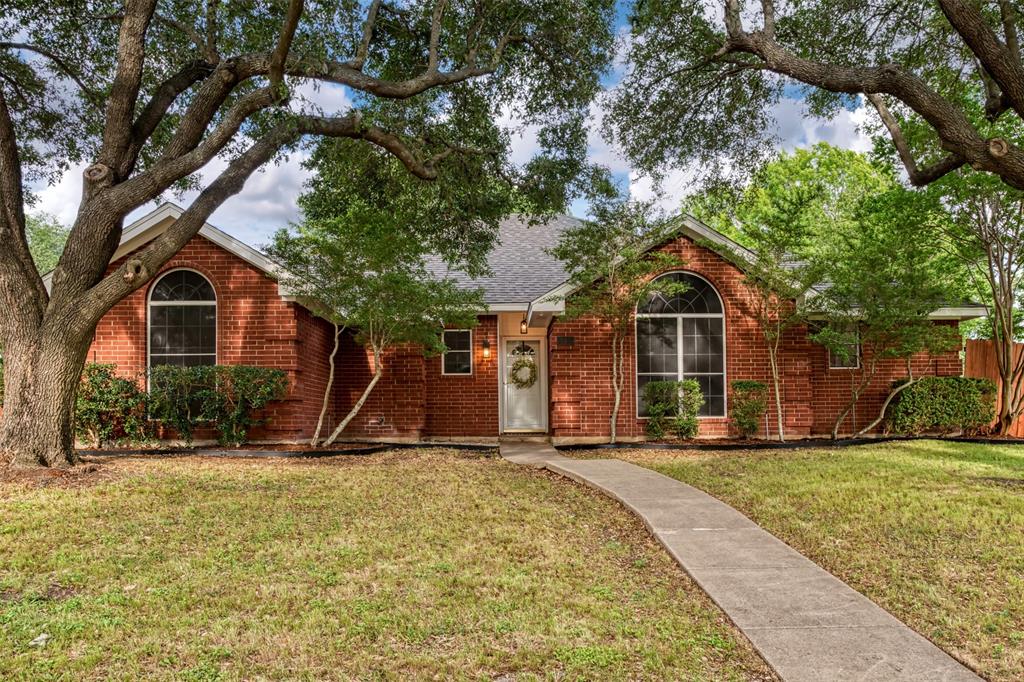 215 Barbara Way Red Oak, TX 75154 - Photo 2 of 36 Classic brick curb appeal framed by mature trees, offering a warm first impression and the kind of established neighborhood feel buyers appreciate.