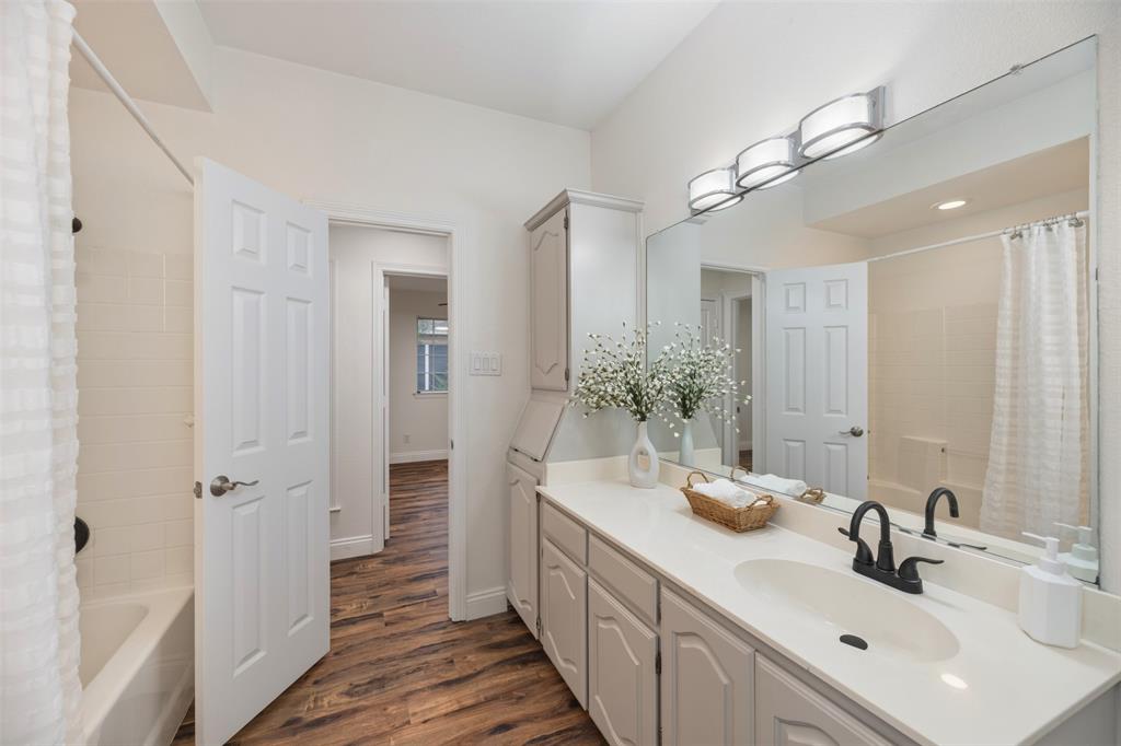 215 Barbara Way Red Oak, TX 75154 - Photo 28 of 36 Bright vanity area with generous counter space and cabinets that provide convenience and help make busy mornings easier.
