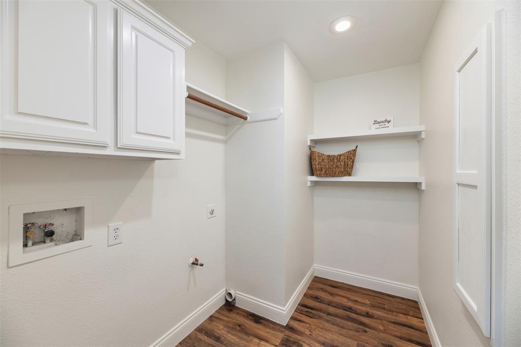 215 Barbara Way Red Oak, TX 75154 - Photo 29 of 36 Laundry room with built-in storage potential — a dedicated utility space with upper cabinets and room to keep household essentials tucked away. Convenient built-in ironing board.