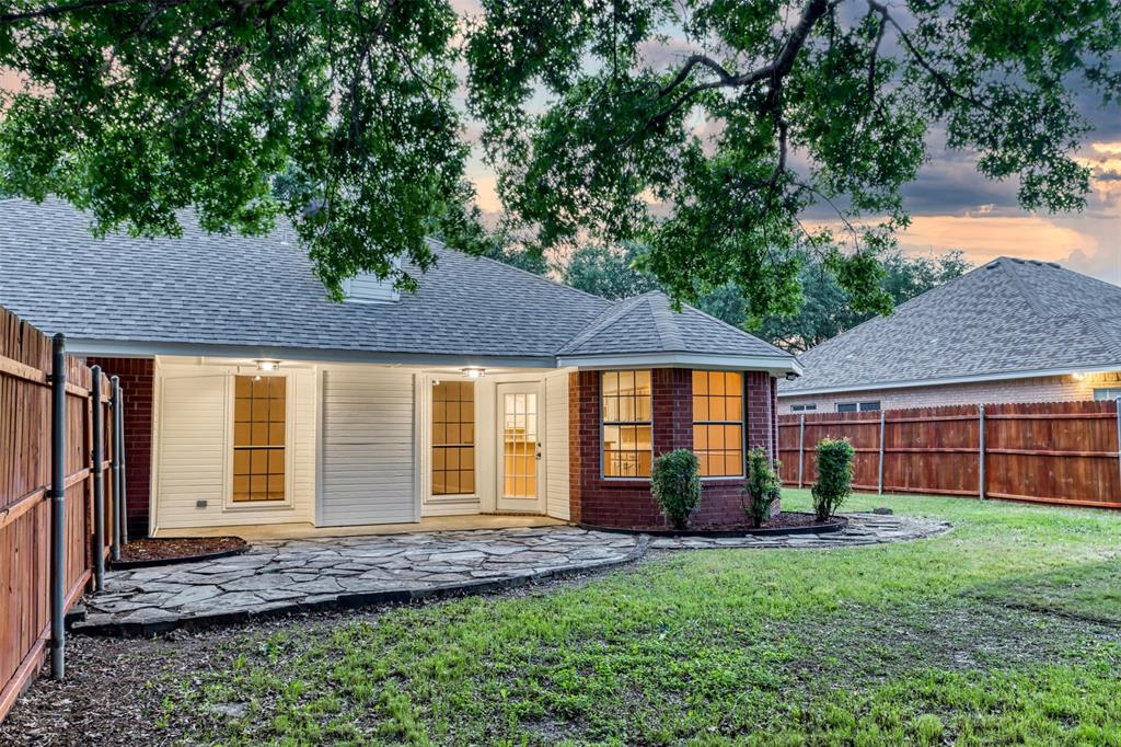 215 Barbara Way Red Oak, TX 75154 - Photo 30 of 36 Welcoming back exterior with mature shade trees with a comfortable space for gathering.