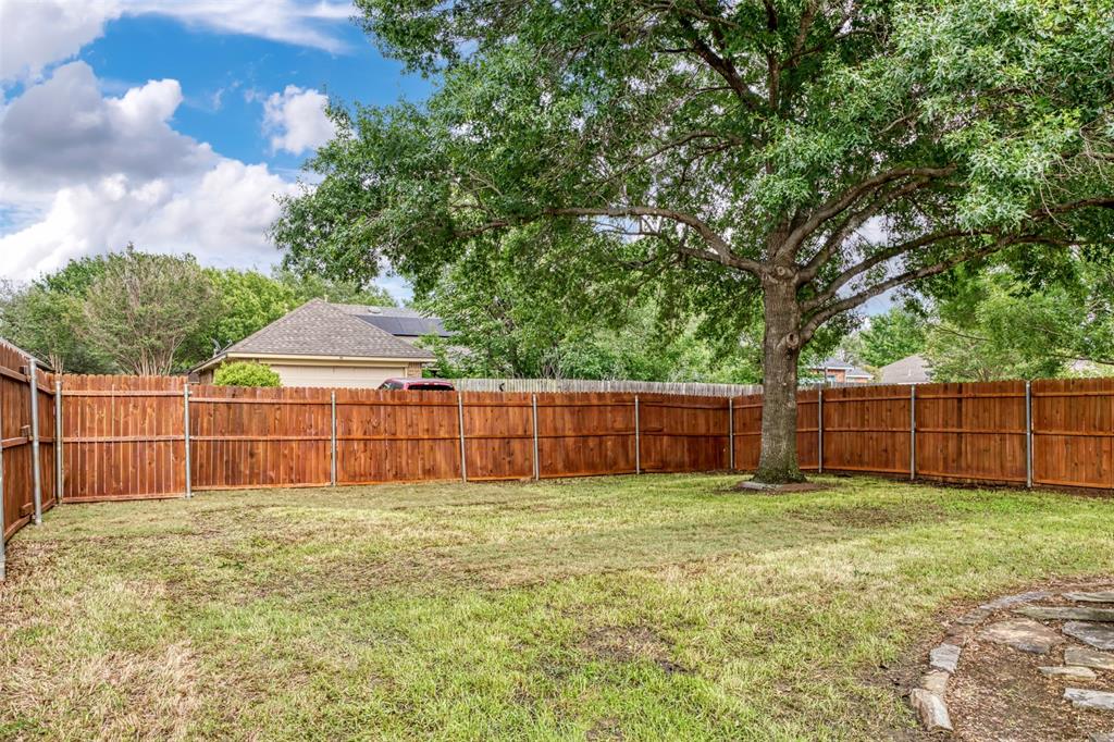 215 Barbara Way Red Oak, TX 75154 - Photo 33 of 36 Spacious fenced backyard with mature treesA generous backyard offers room to play, garden, relax, or create an outdoor living space. The wood privacy fence and mature trees add a comfortable setting with plenty of everyday potential.