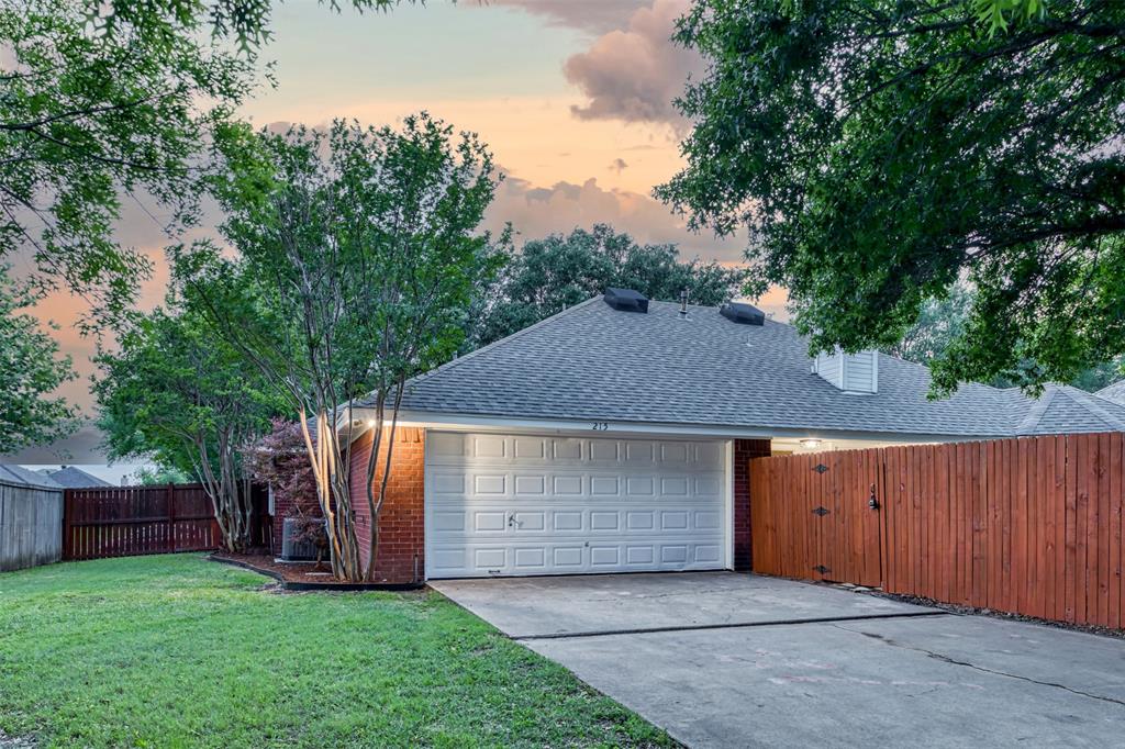 215 Barbara Way Red Oak, TX 75154 - Photo 35 of 36 Attached two-car garage and wide drivewayConvenient rear-entry garage and extended driveway provide practical parking and easy daily access. A great feature for buyers wanting function, storage, and affordability in one place.