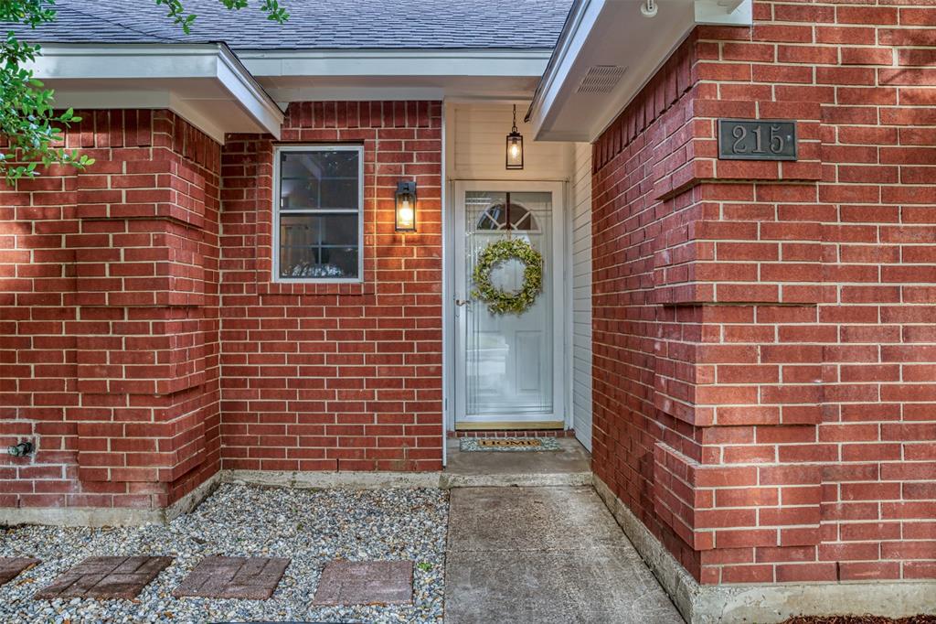 215 Barbara Way Red Oak, TX 75154 - Photo 5 of 36 Covered front entry adds everyday convenience, offering a protected transition into the home and a welcoming place for seasonal décor.