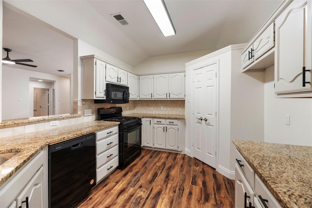215 Barbara Way Red Oak, TX 75154 - Photo 10 of 36 Functional kitchen with generous cabinet, counter space and pantry offer the chef of the house a practical layout for cooking, storage, and future personalization.