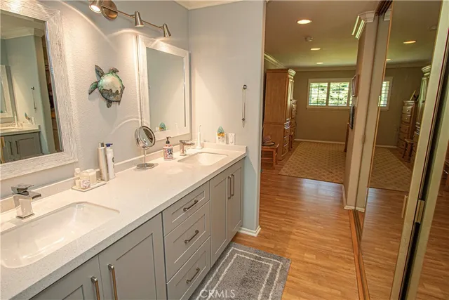 a spacious bathroom with a double vanity sink and mirror