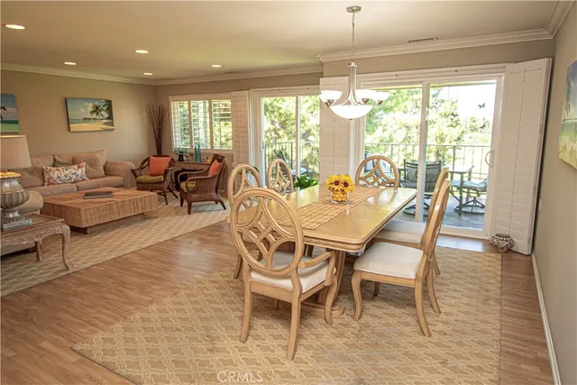 a dining room with furniture a chandelier and wooden floor