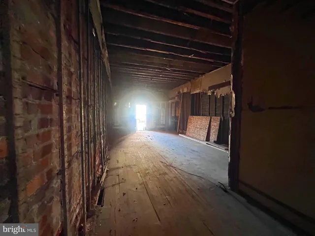 a view of hallway with wooden floor