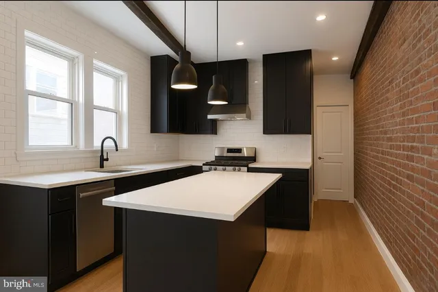 a kitchen with a sink and a refrigerator