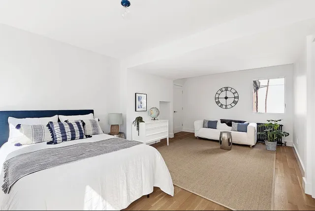 a bedroom with furniture and window