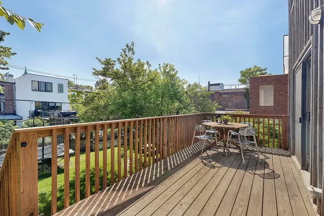 a view of balcony with wooden floor and fence