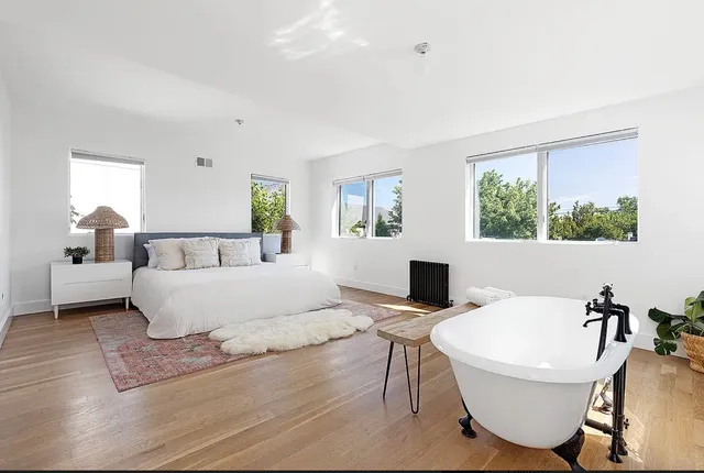 a living room with couches a coffee table and a flat screen tv
