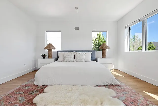 a large white bed in a white room