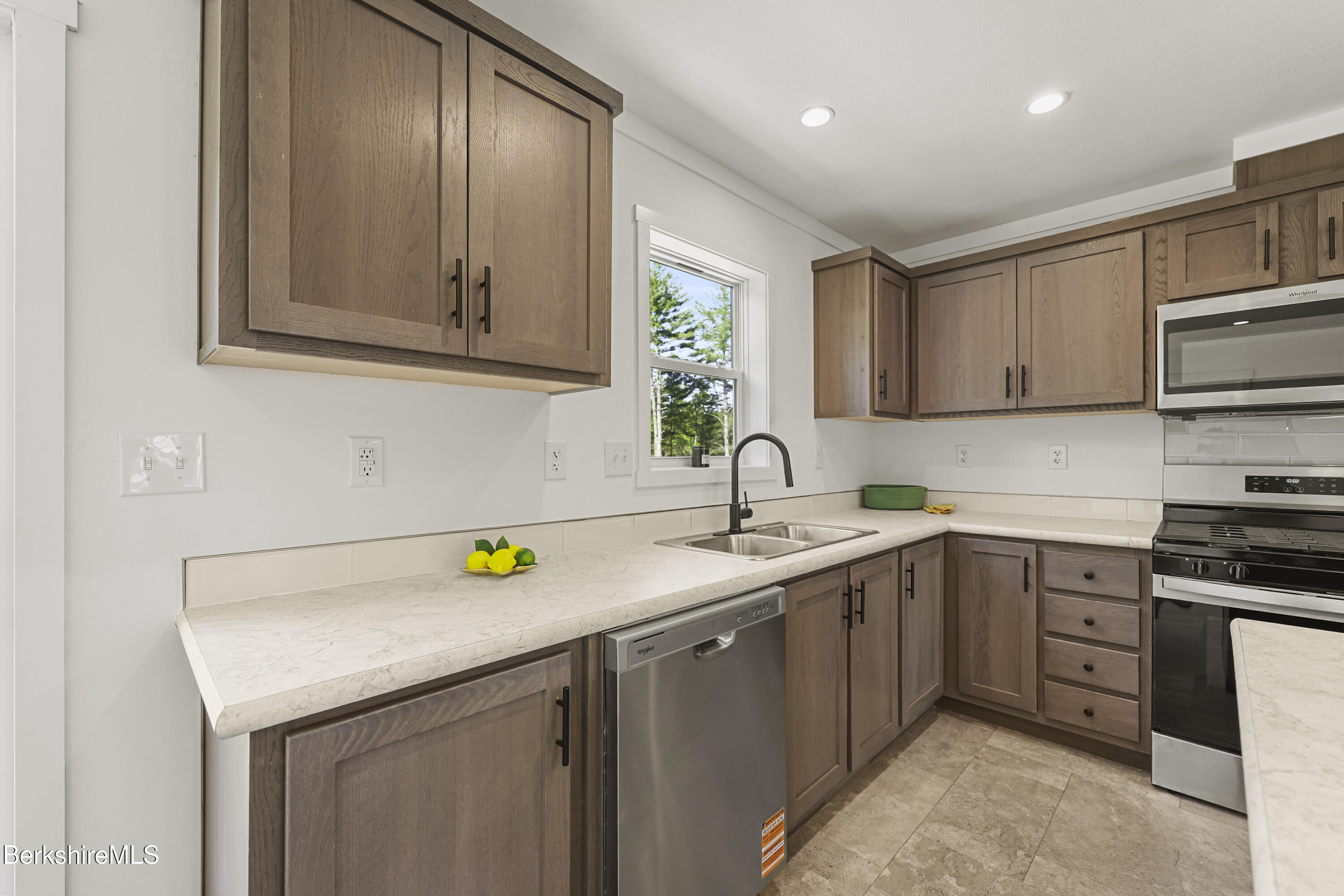 395 Cheshire Road, Unit 112 Pittsfield, MA 01201 - Photo 12 of 32 a kitchen with a sink a stove and cabinets