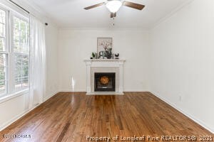 Undisclosed Address Pinehurst, NC 28374 - Photo 12 of 29 a view of an empty room with wooden floor fireplace and a window
