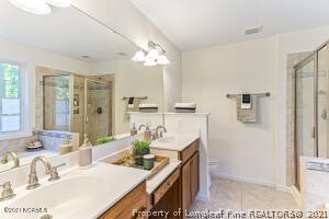 Undisclosed Address Pinehurst, NC 28374 - Photo 16 of 29 a bathroom with a granite countertop sink a toilet and mirror