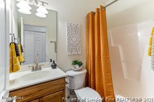 Undisclosed Address Pinehurst, NC 28374 - Photo 23 of 29 a bathroom with a sink a mirror and a toilet