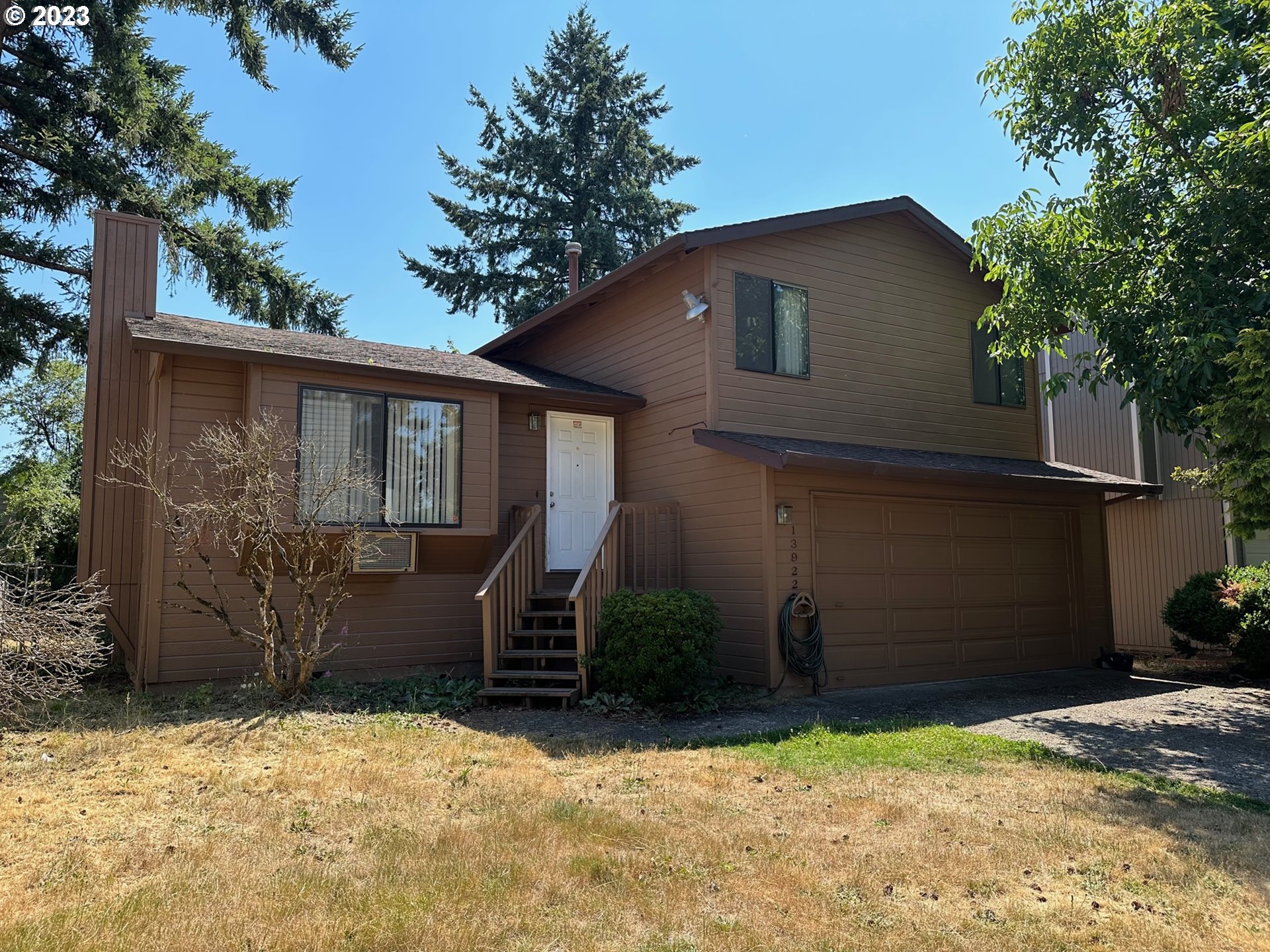 13922 Southeast Bush Street Portland, OR 97236 - Photo 1 of 29 a front view of a house with garden