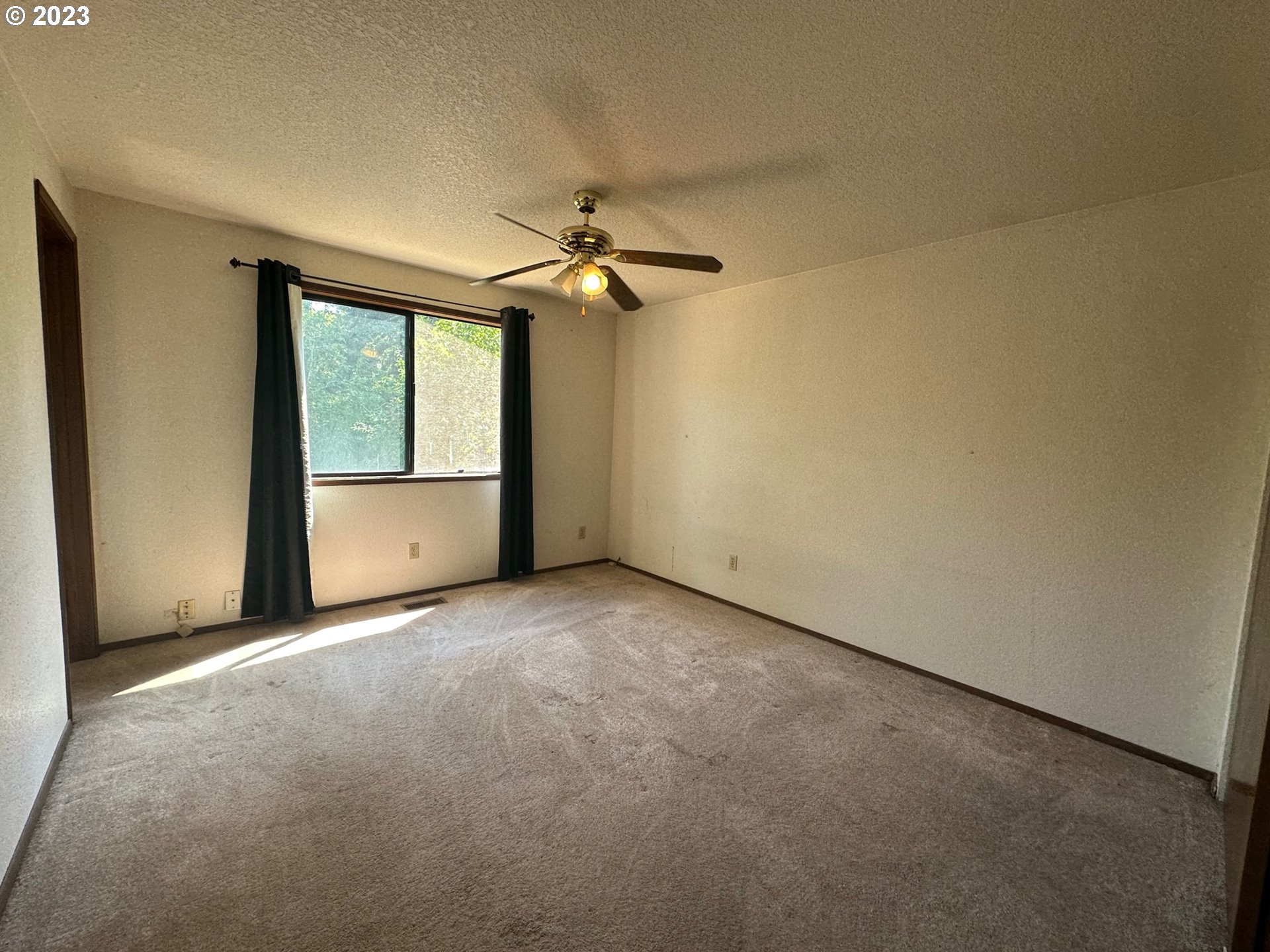 13922 Southeast Bush Street Portland, OR 97236 - Photo 16 of 29 an empty room with windows and fan