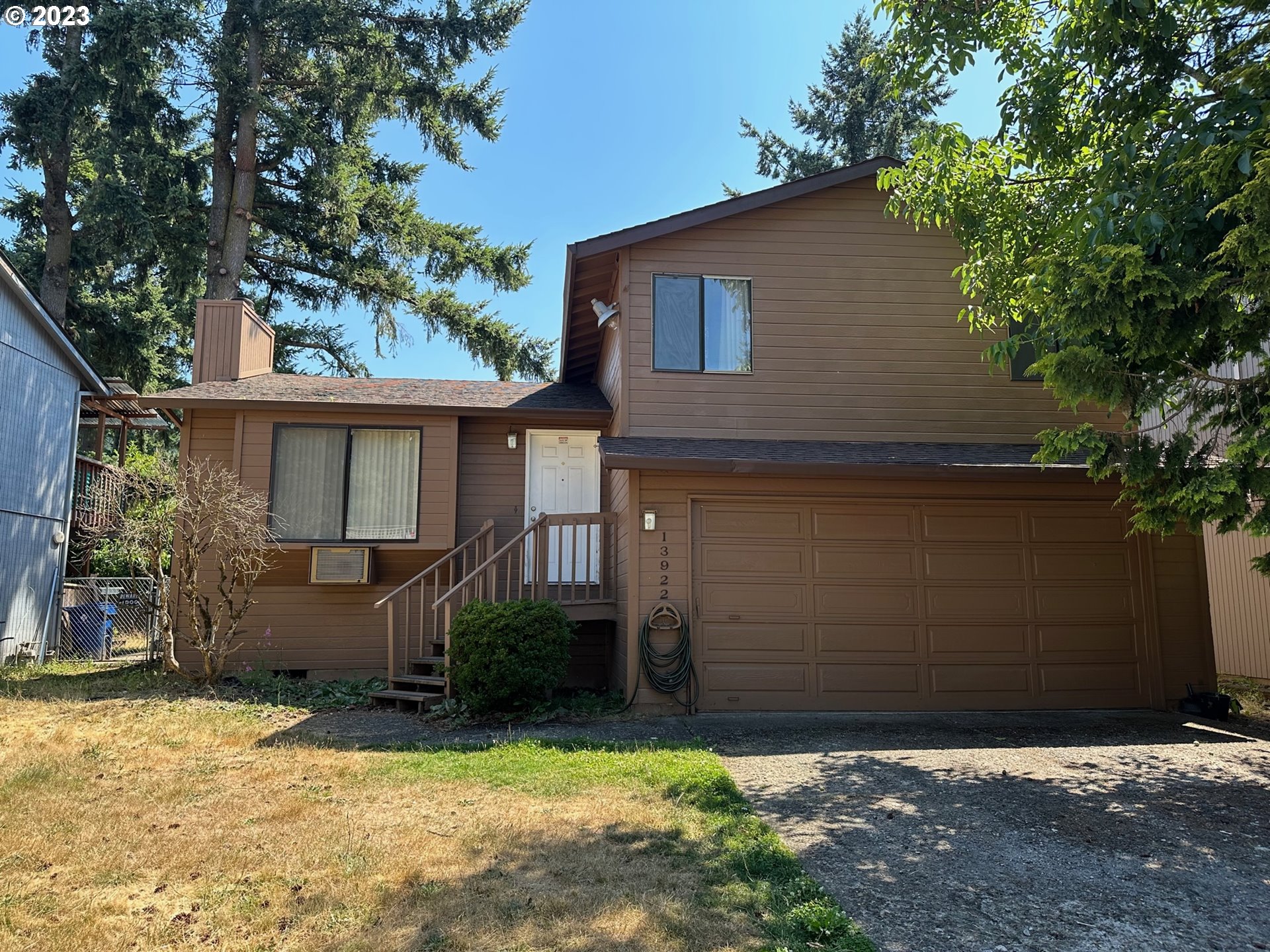 13922 Southeast Bush Street Portland, OR 97236 - Photo 3 of 29 a front view of a house with a yard