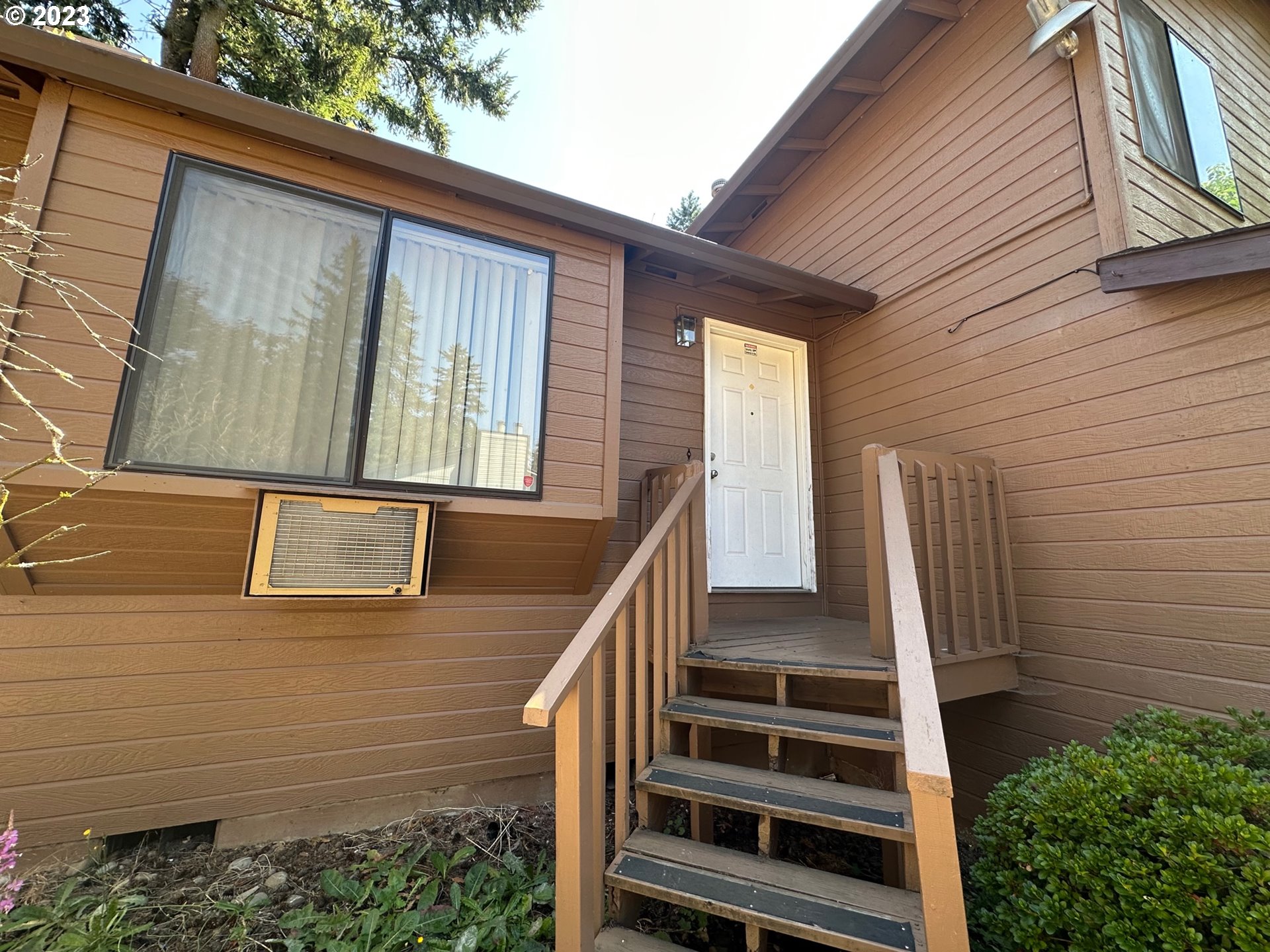 13922 Southeast Bush Street Portland, OR 97236 - Photo 4 of 29 a view of a house with stairs and wooden floor