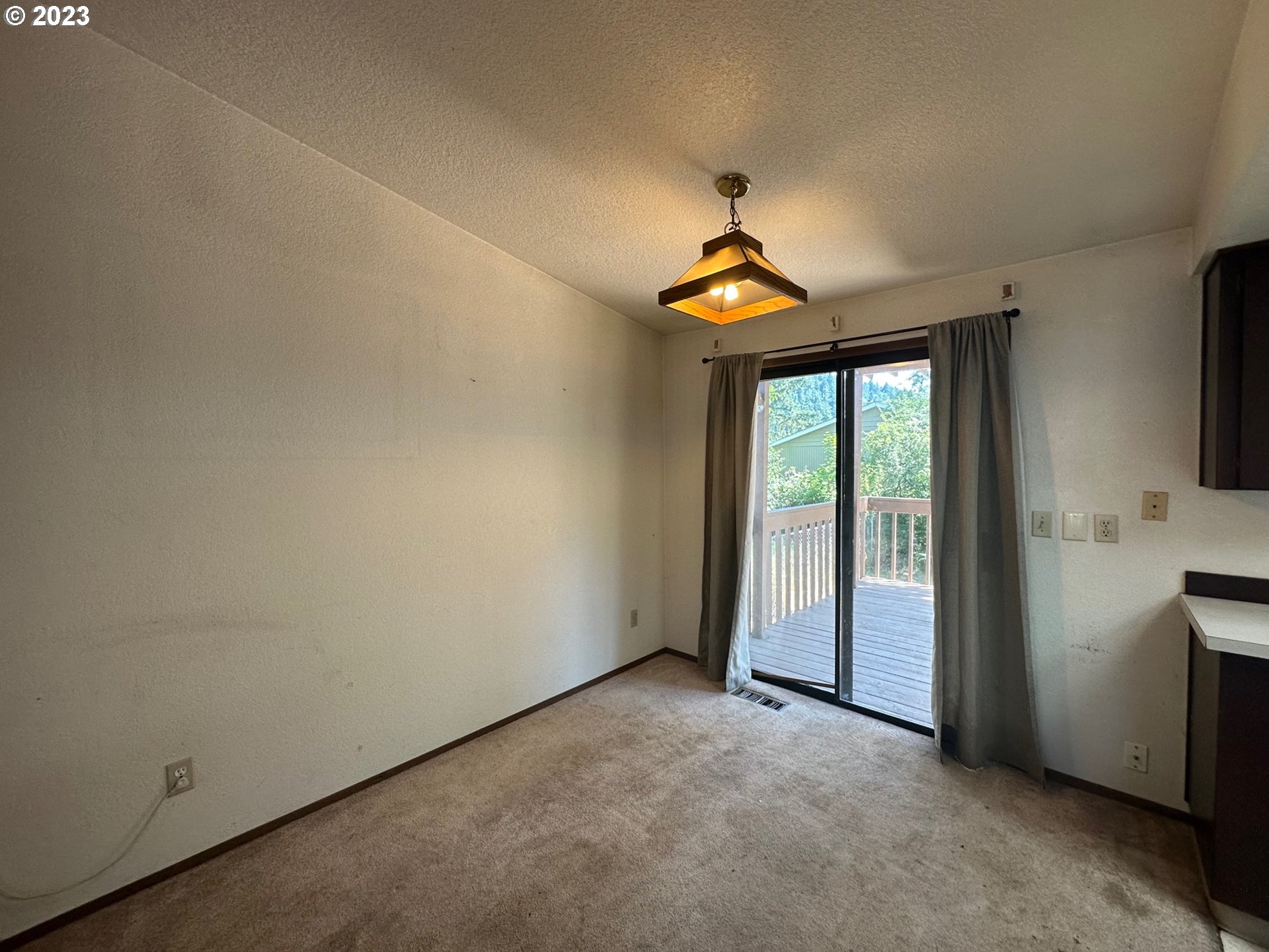13922 Southeast Bush Street Portland, OR 97236 - Photo 8 of 29 an empty room with windows and ceiling fan