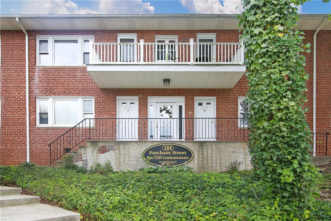 184 Purchase Street, Unit 16 Rye, NY 10580 - Photo 1 of 1 a front view of a house with garden