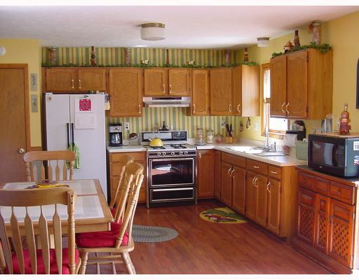 201 Powell Road New Brighton, PA 15066 - Photo 10 of 16 Kitchen. Kitchen is spacious and bright with plentiful oak cabinetry and hardwood flooring. Acess the deck through the sliding glass door and take entertaining outdoors.