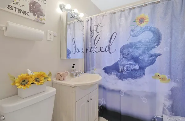 a bedroom with a bed and a dresser next to a window