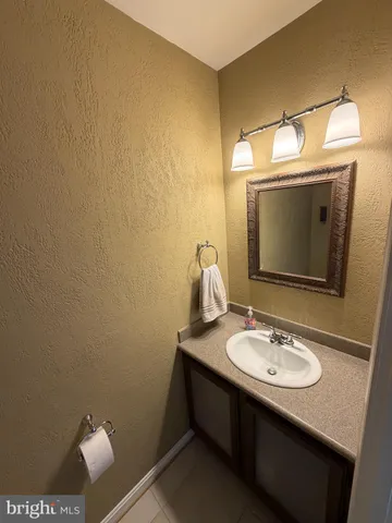 a bathroom with a sink toilet and mirror
