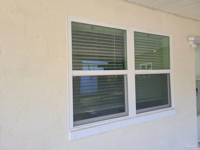 a view of a wooden door and a window