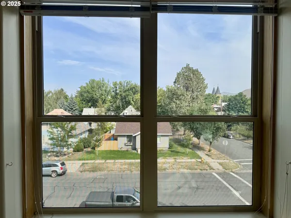 a view of a livingroom with a ceiling fan and window