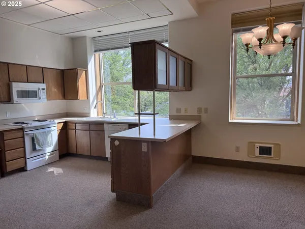 a kitchen with sink a window and stainless steel appliances