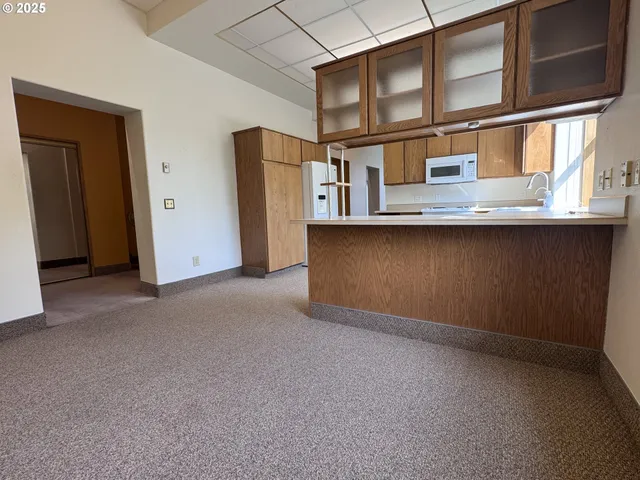 a view of an empty room with a cabinet
