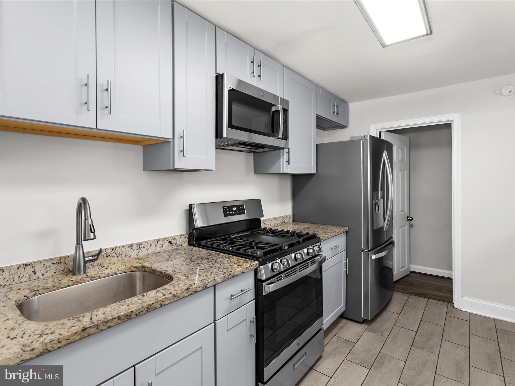 7821 Rockbourne Road Baltimore, MD 21222 - Photo 11 of 56 a kitchen with stainless steel appliances granite countertop a sink stove and refrigerator