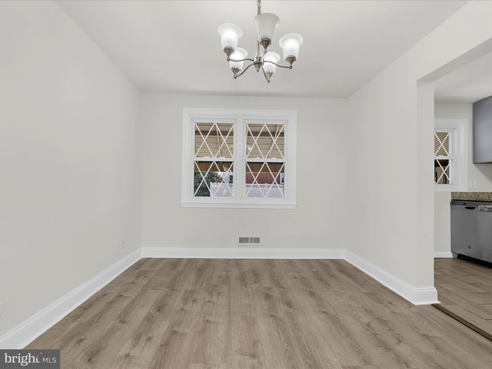 7821 Rockbourne Road Baltimore, MD 21222 - Photo 8 of 56 wooden floor in an empty room with a window