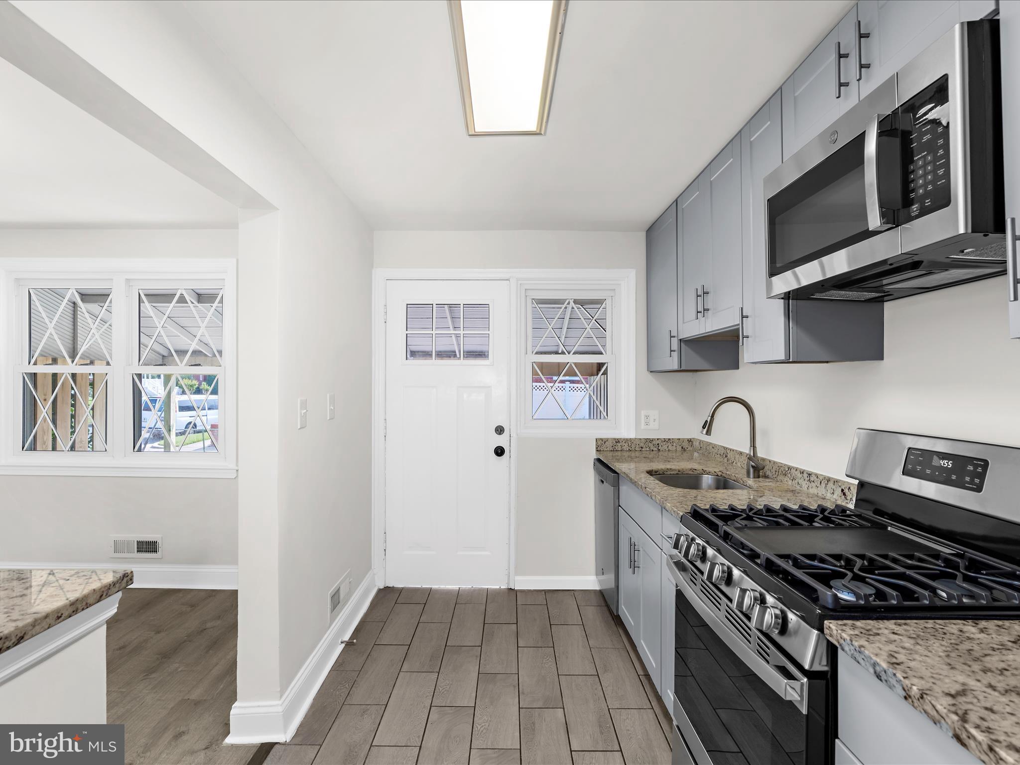 7821 Rockbourne Road Baltimore, MD 21222 - Photo 10 of 56 a kitchen with stainless steel appliances granite countertop a stove and a microwave