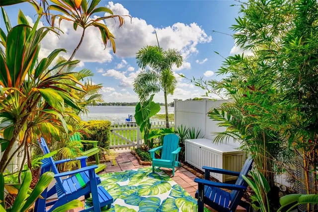 a backyard of a house with lots of green space and outdoor seating
