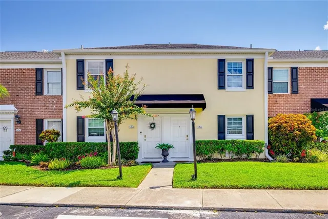 a front view of a house with a garden and garage