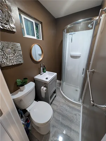 a white toilet sitting next to a bathroom sink