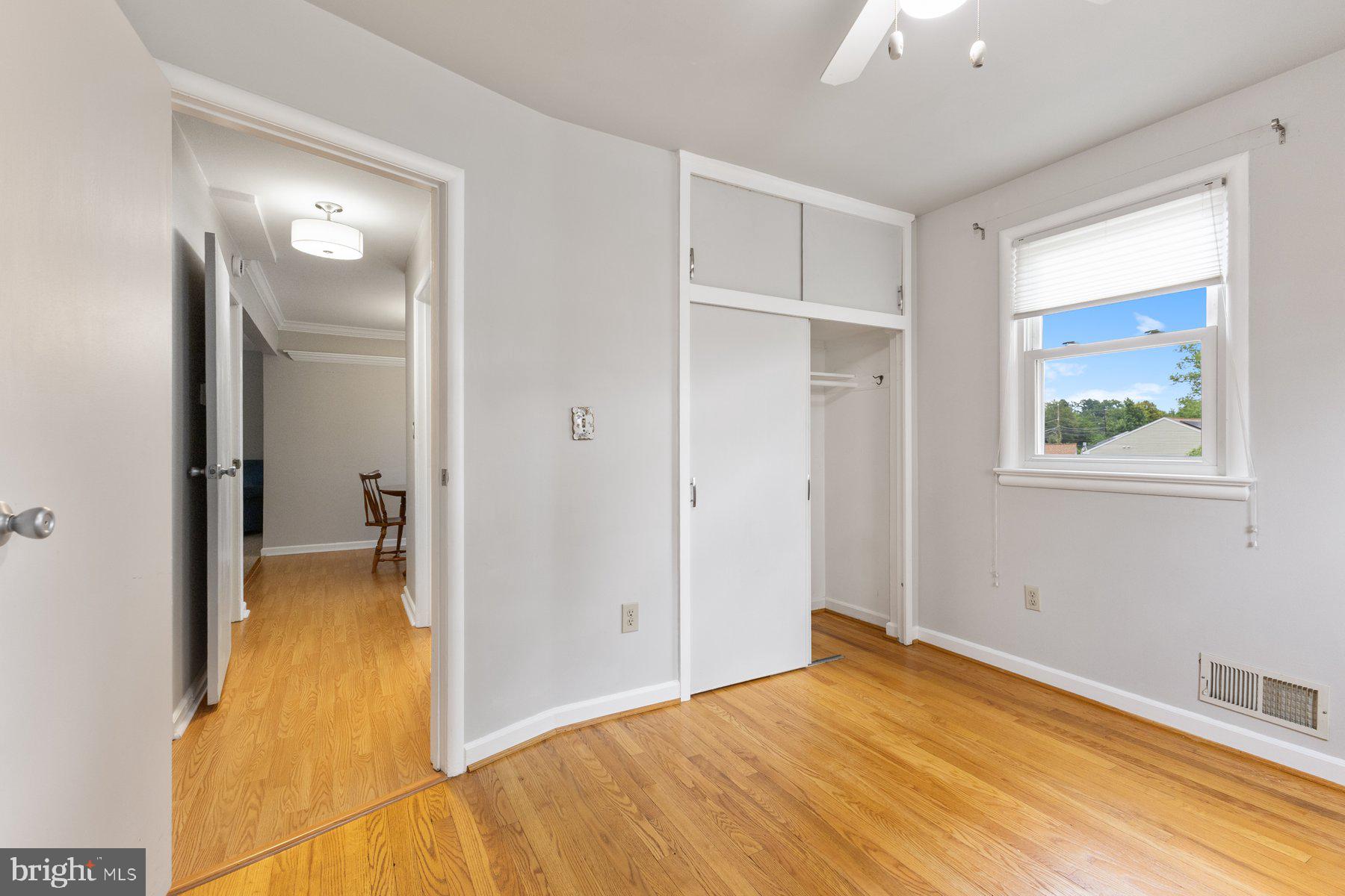 12703 Bluhill Road Silver Spring, MD 20906 - Photo 17 of 41 a view of a bedroom with wooden floor and a bathroom