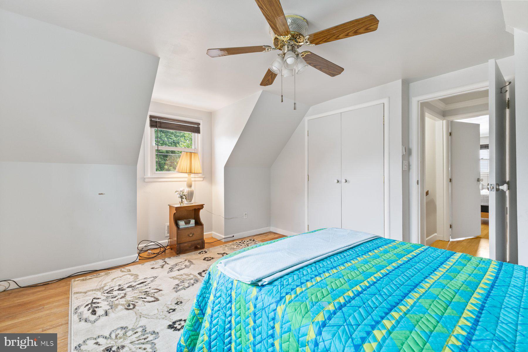 12703 Bluhill Road Silver Spring, MD 20906 - Photo 25 of 41 a bedroom with a bed and a chandelier