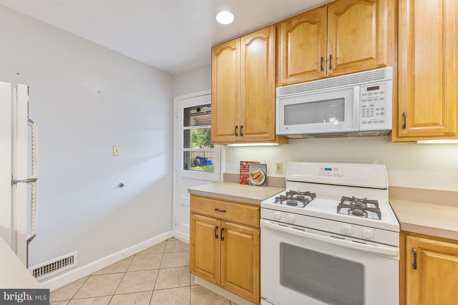 12703 Bluhill Road Silver Spring, MD 20906 - Photo 10 of 41 a kitchen with stainless steel appliances white cabinets and a stove top oven