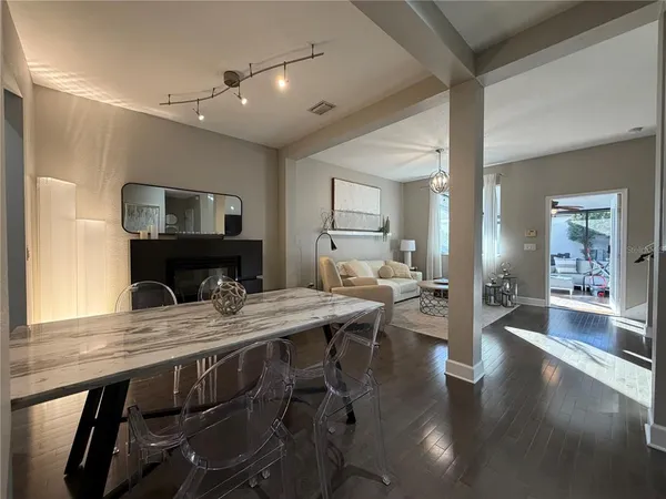 a living room with furniture ceiling fan and a large window