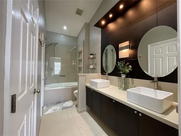 a bathroom with a double vanity sink and a mirror